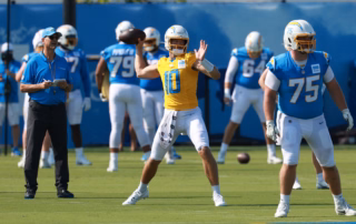 Justin Herbert throwing a pass at camp